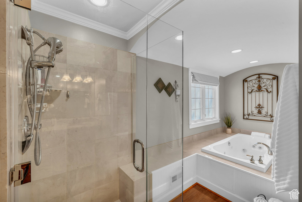 Bathroom featuring a tub with jets, ornamental molding, a stall shower, and recessed lighting