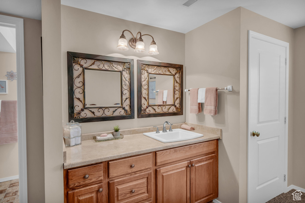 Bathroom featuring vanity and baseboards