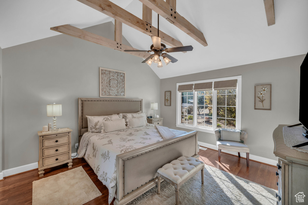 Bedroom with dark wood-style floors, ceiling fan, baseboards, and vaulted ceiling with beams
