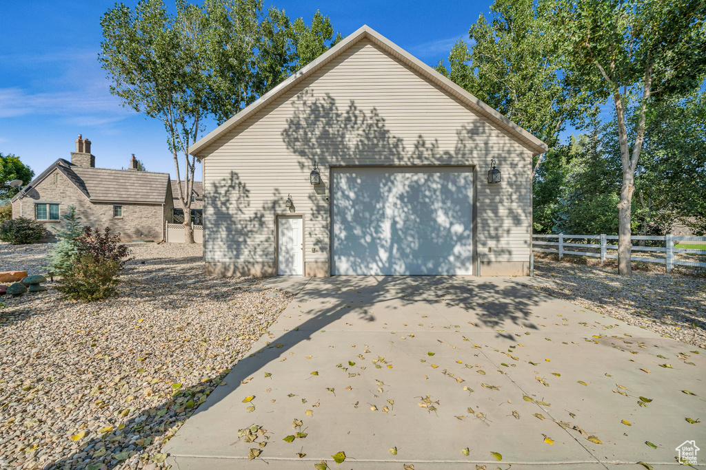Detached garage with fence and driveway