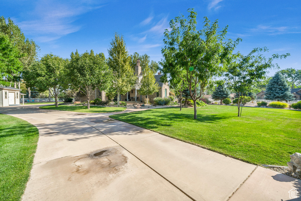Surrounding community featuring a garage, a yard, and concrete driveway