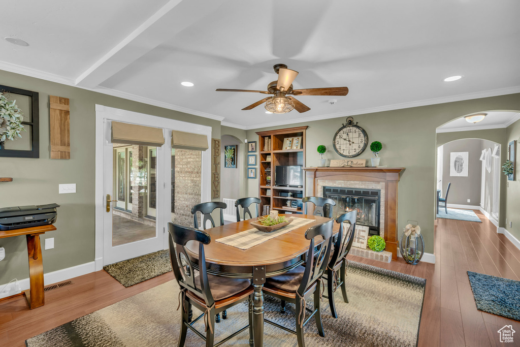 Dining space with crown molding, hardwood / wood-style floors, and ceiling fan