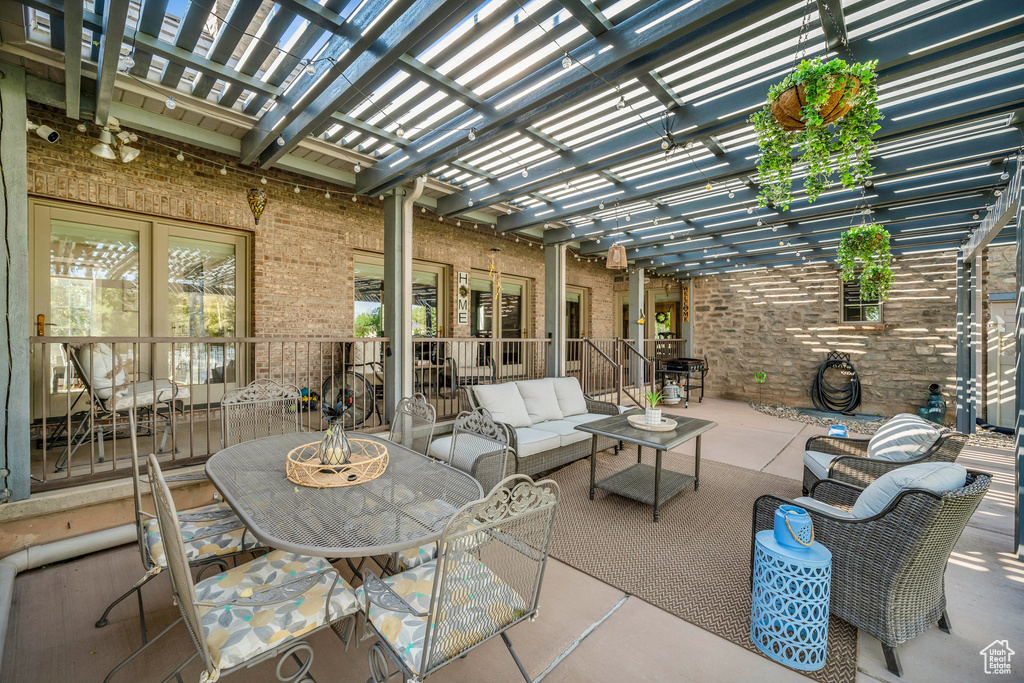 View of patio / terrace featuring an outdoor living space, a pergola, and french doors