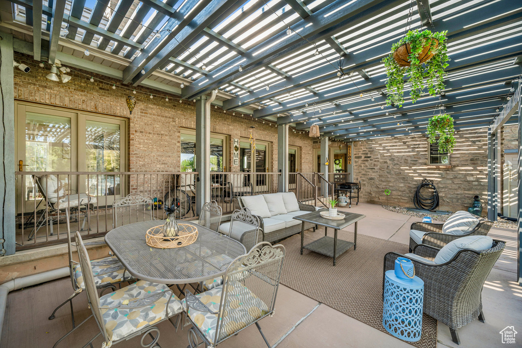 View of patio featuring outdoor dining area, outdoor lounge area, and a pergola
