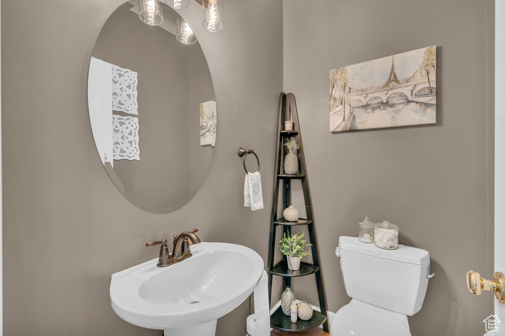 Half bathroom featuring toilet and a sink