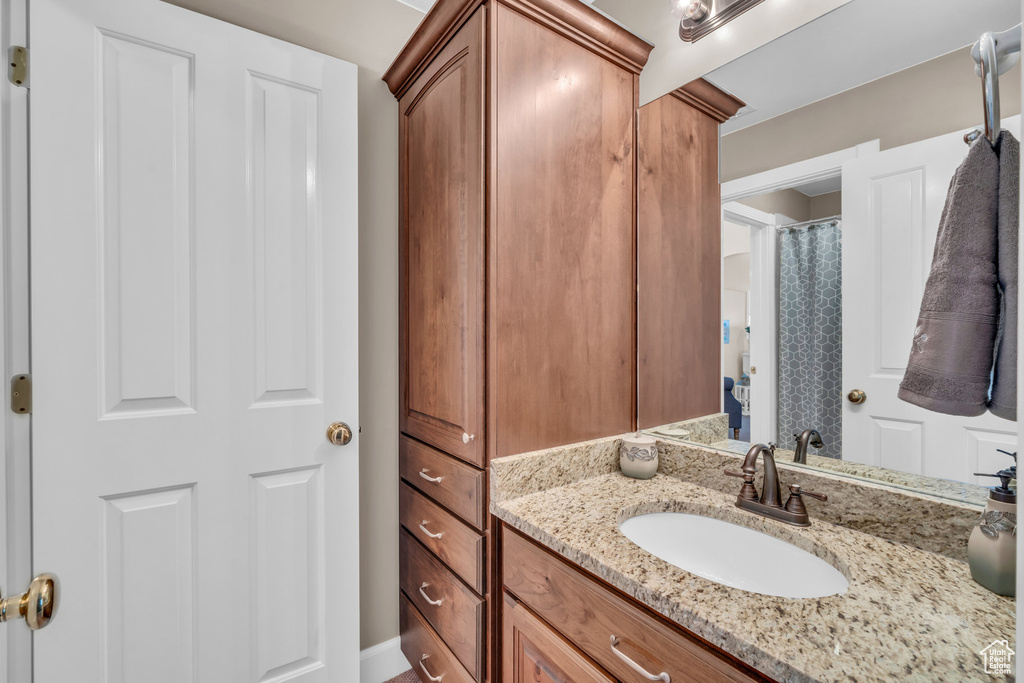 Bathroom with vanity and a shower with shower curtain