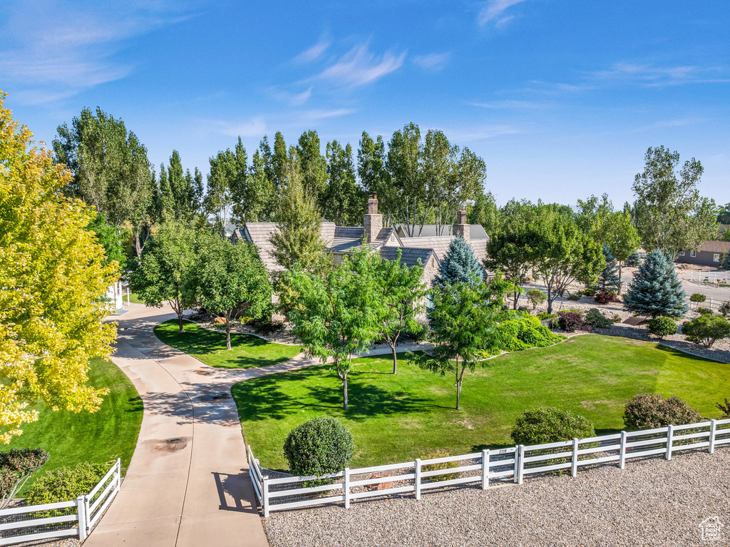 View of community with a yard and fence
