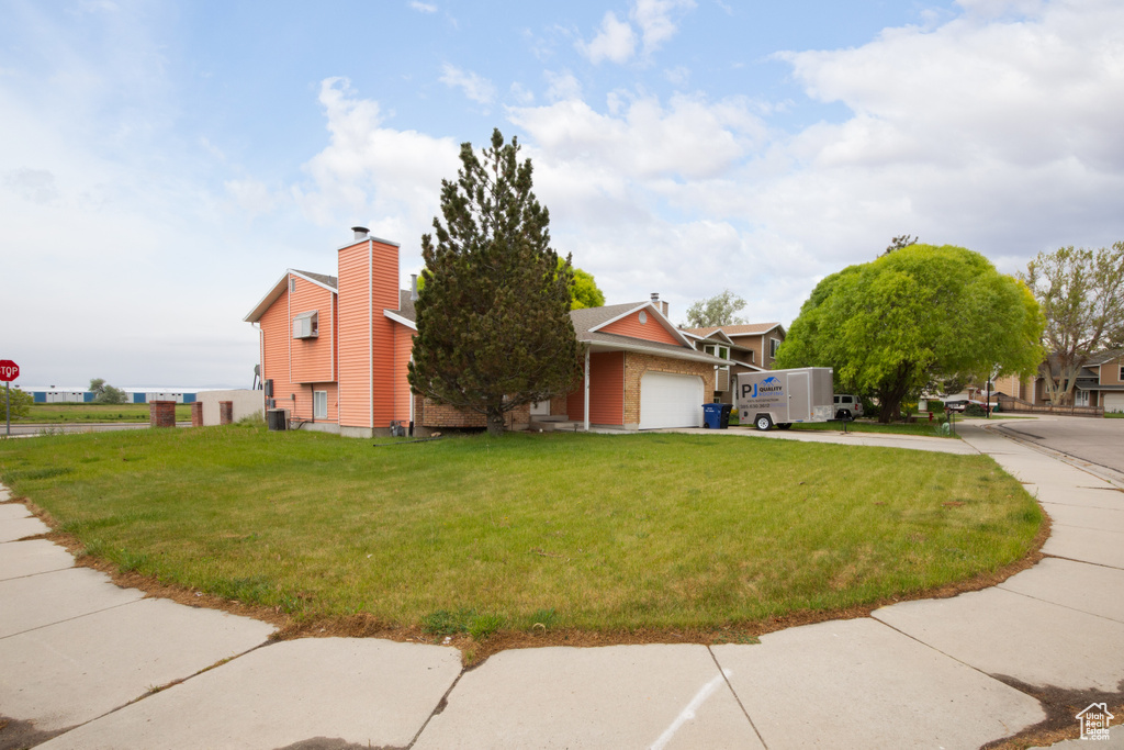 Exterior space featuring a garage and a front yard