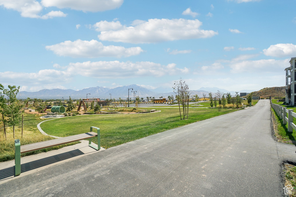 View of property's community featuring a lawn and a mountain view