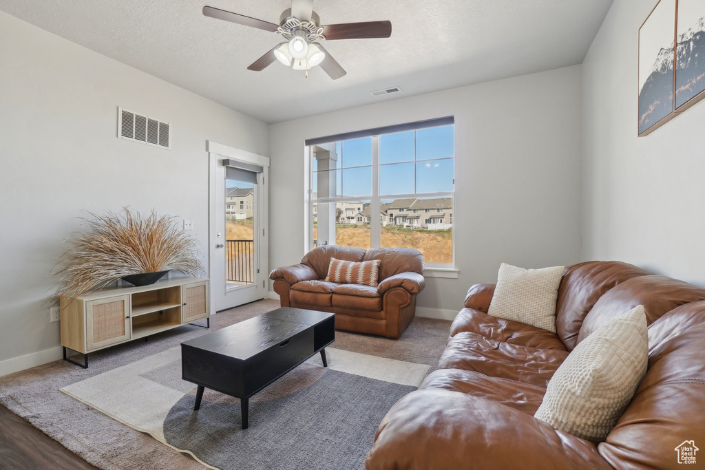 Living room with light wood-type flooring and ceiling fan