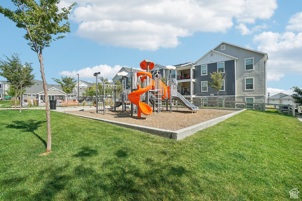 View of jungle gym with a lawn