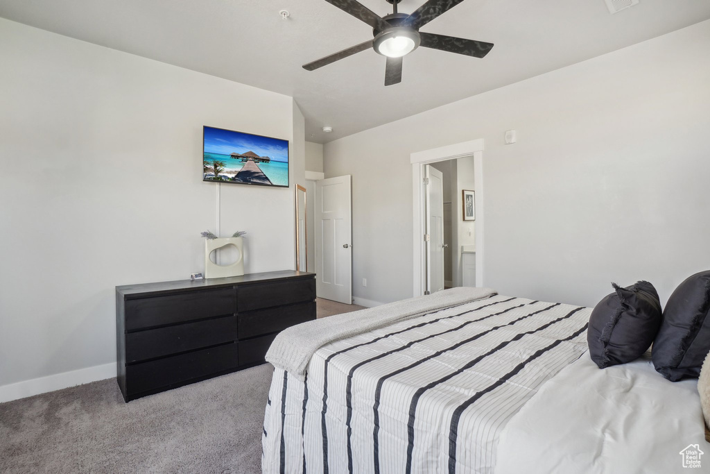 Bedroom featuring lofted ceiling, ceiling fan, and light carpet