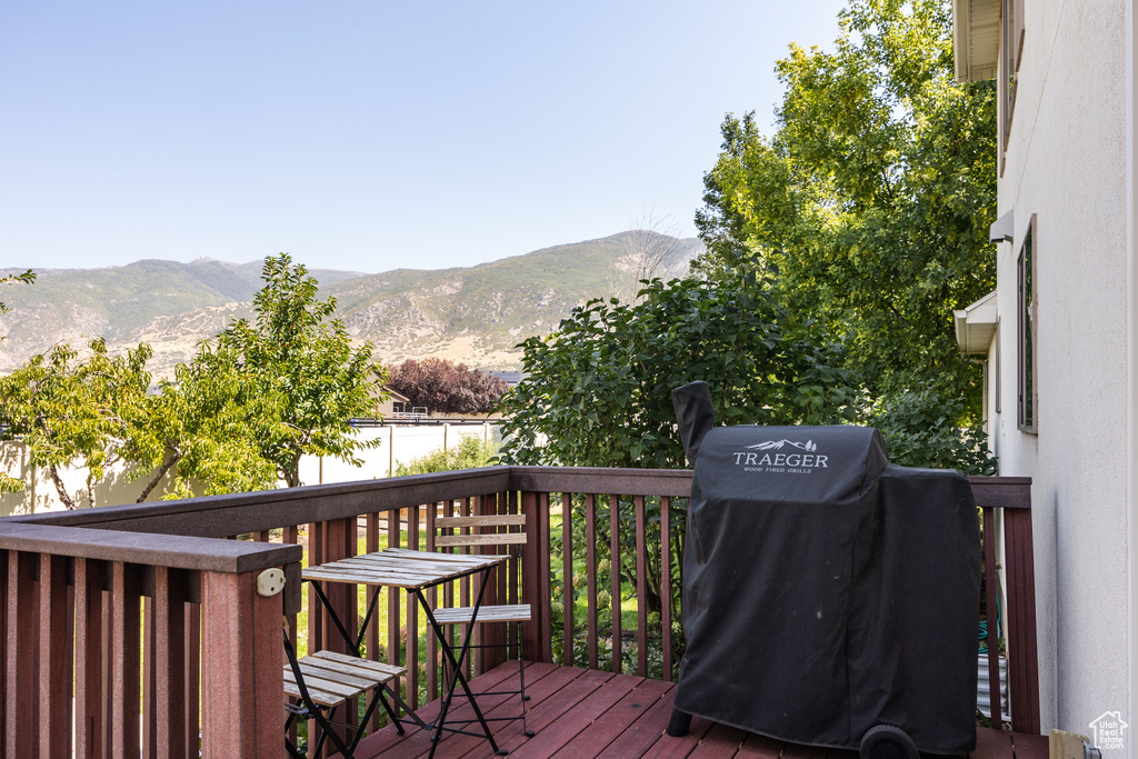 Wooden terrace featuring a mountain view and grilling area