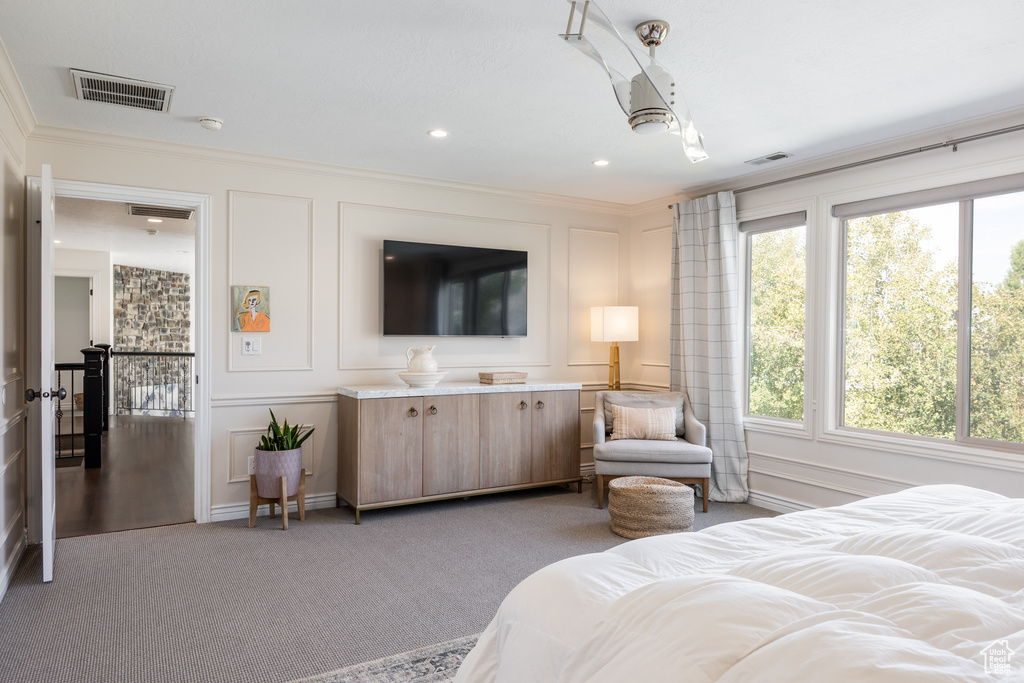 Carpeted bedroom with crown molding