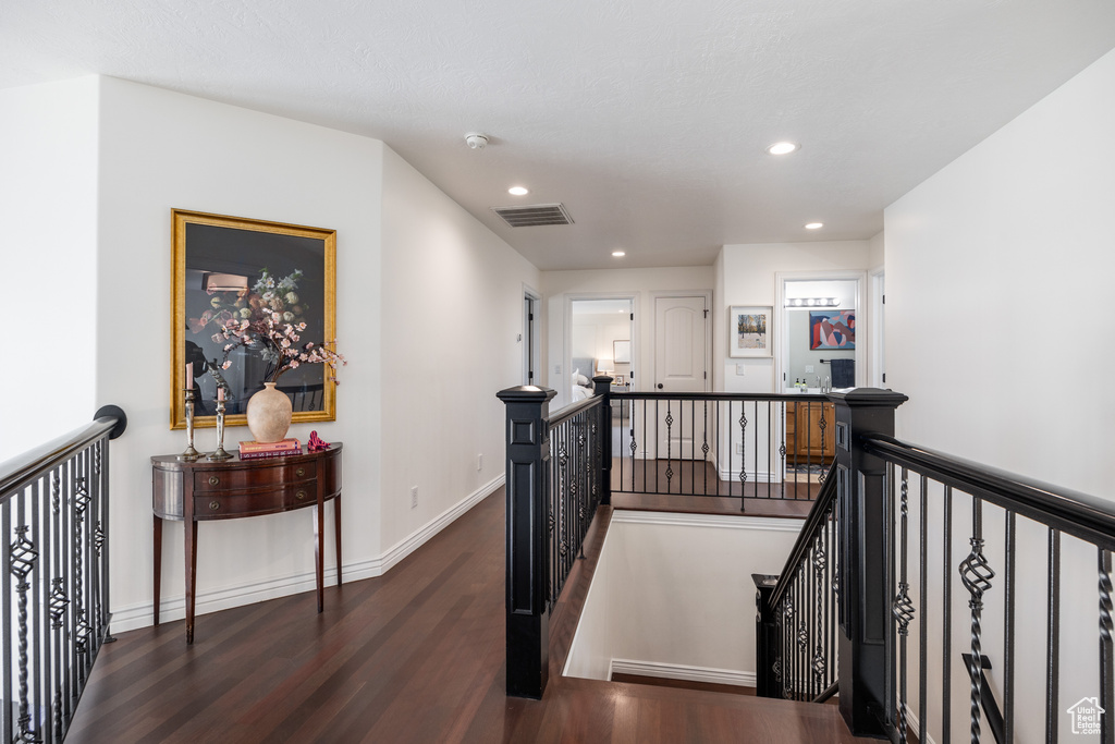 Corridor with dark hardwood / wood-style flooring