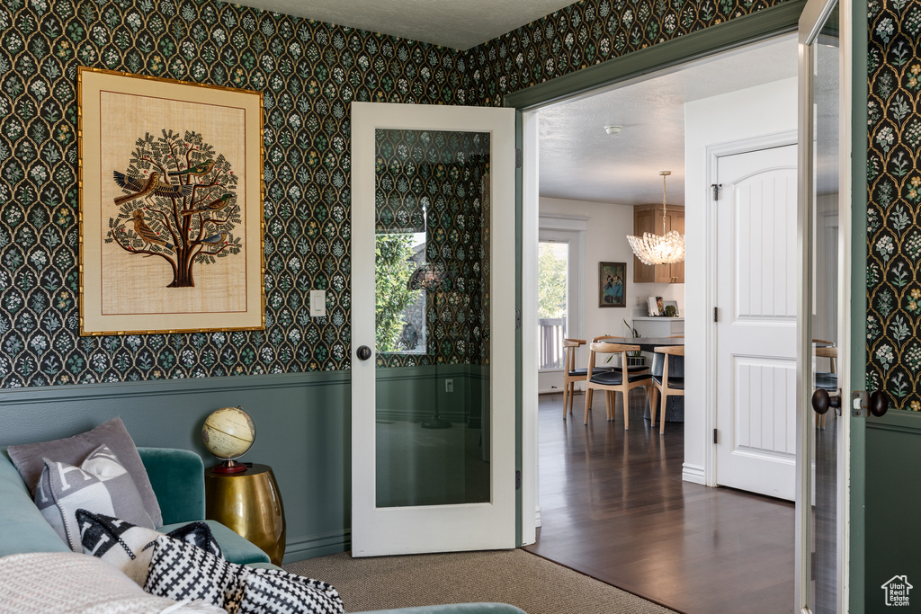 Bedroom with dark wood-type flooring and a notable chandelier