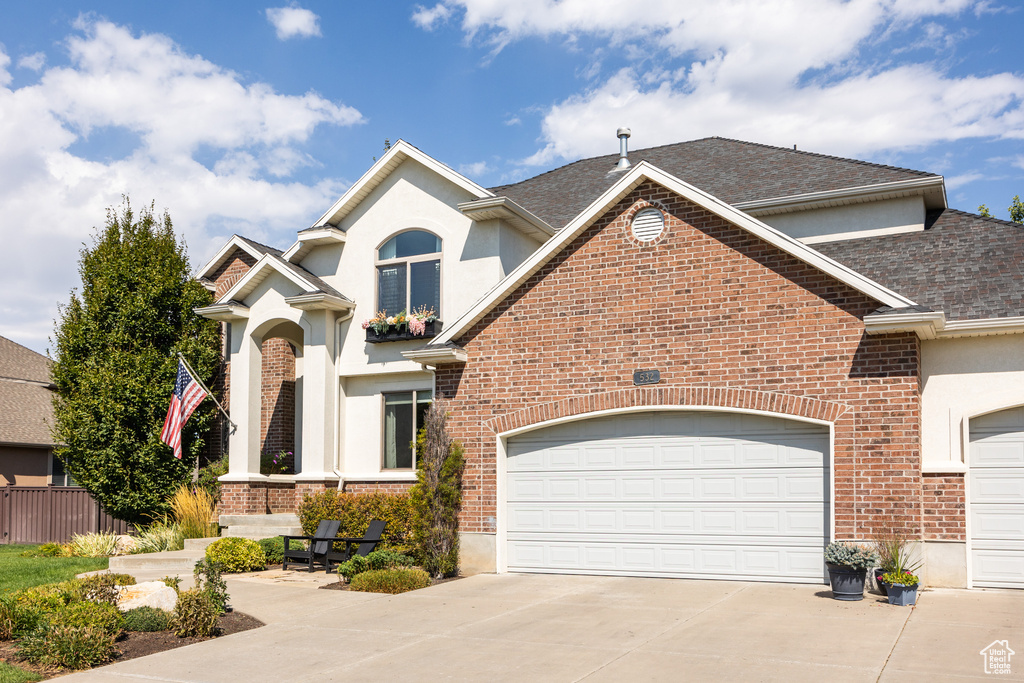 View of front facade featuring a garage