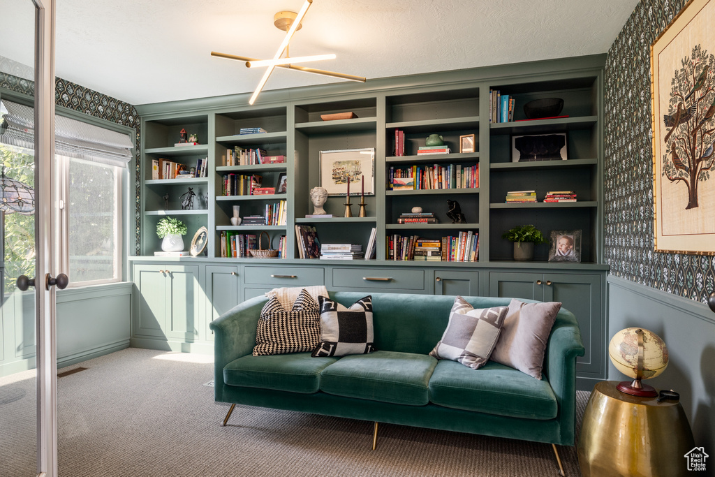 Sitting room with built in shelves and carpet flooring