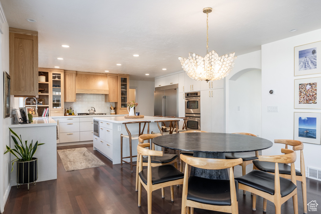 Dining space featuring dark hardwood / wood-style floors and a chandelier