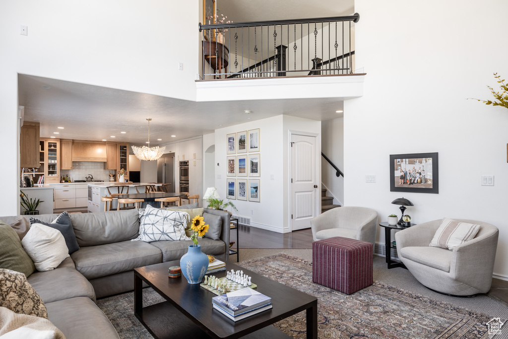 Living room with a high ceiling and an inviting chandelier