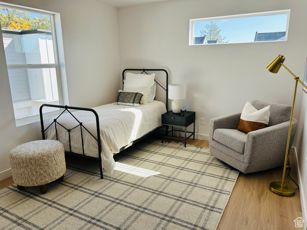 Bedroom with multiple windows and hardwood / wood-style flooring