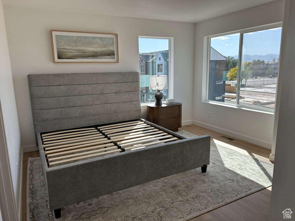 Bedroom featuring a mountain view and hardwood / wood-style flooring