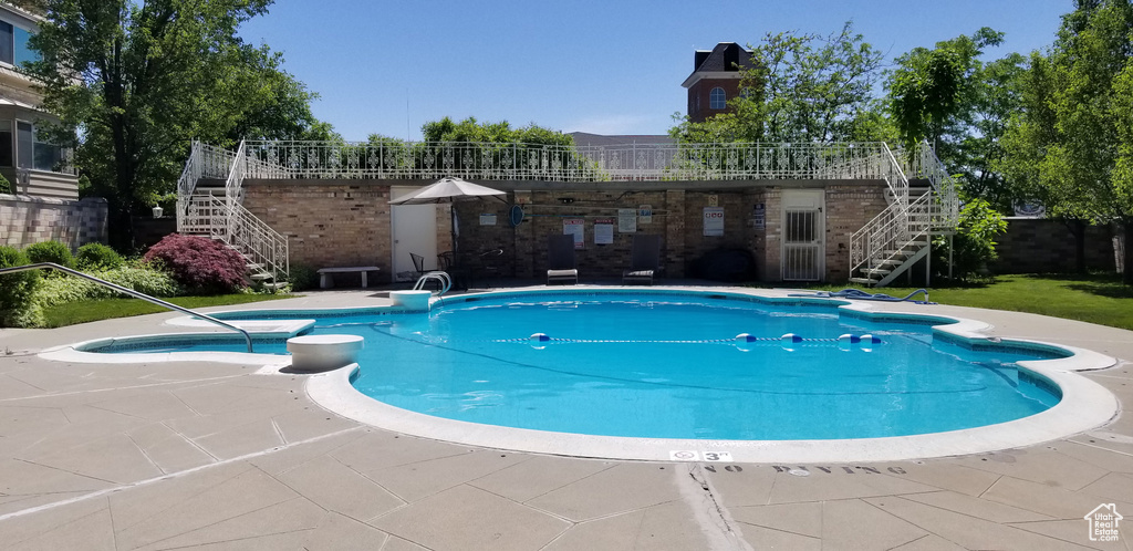 View of swimming pool with a patio area