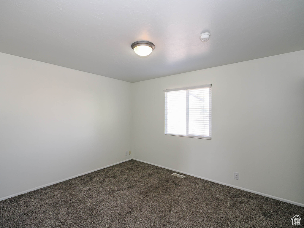 Spare room featuring carpet flooring