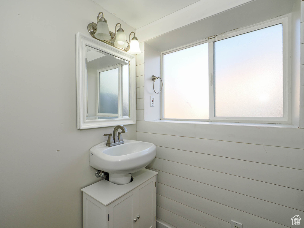 Bathroom featuring vanity and wooden walls