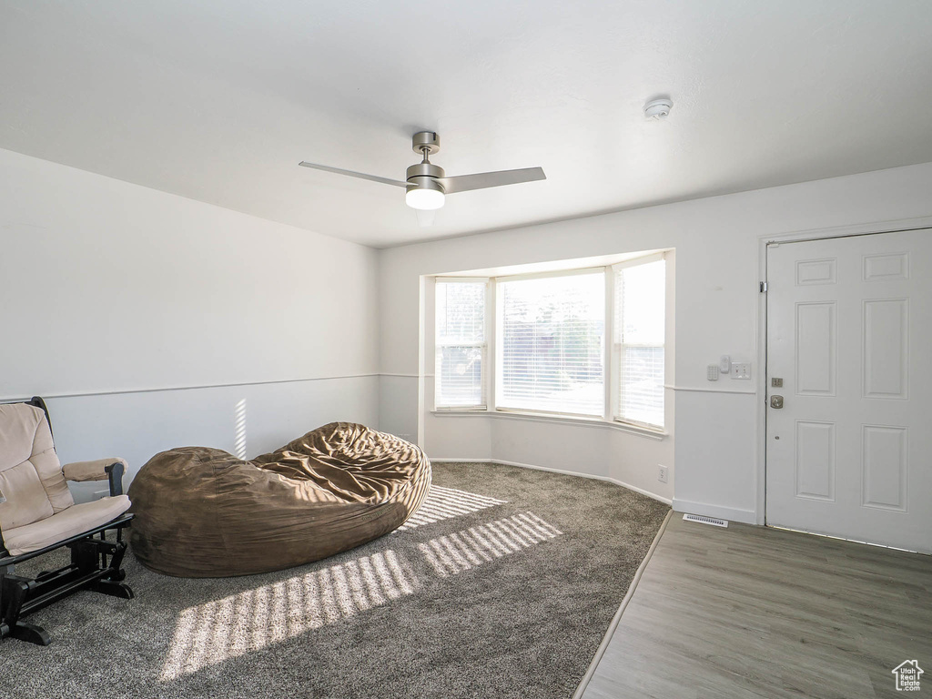 Living area featuring ceiling fan and hardwood / wood-style floors