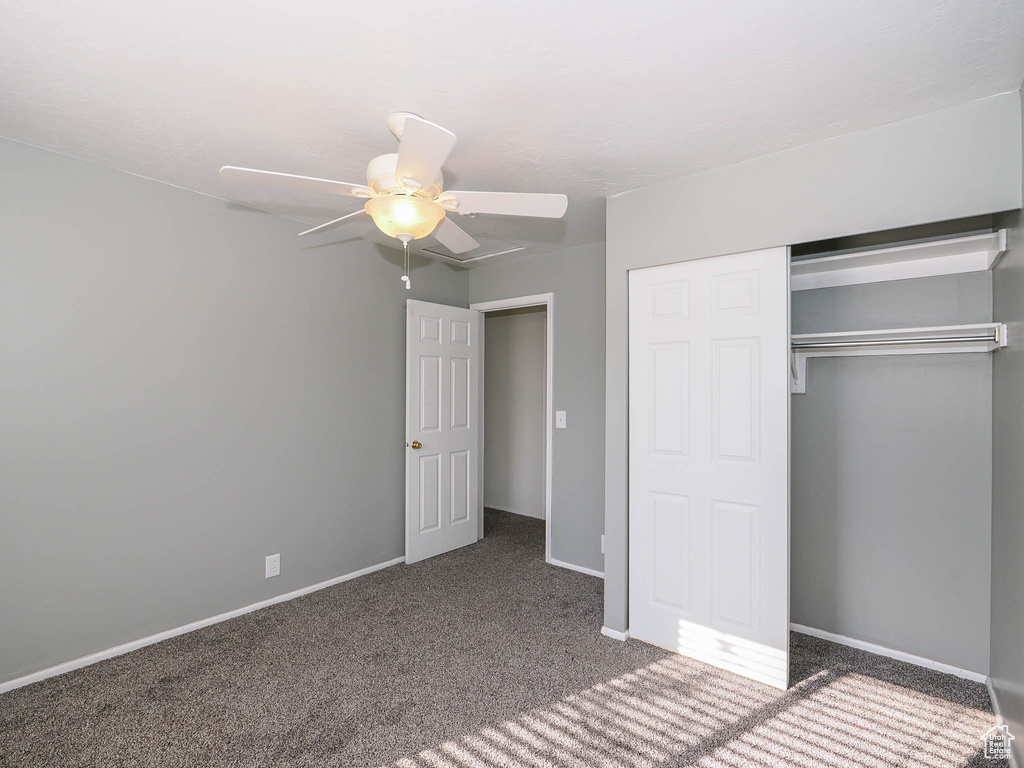 Unfurnished bedroom with carpet floors, ceiling fan, and a closet