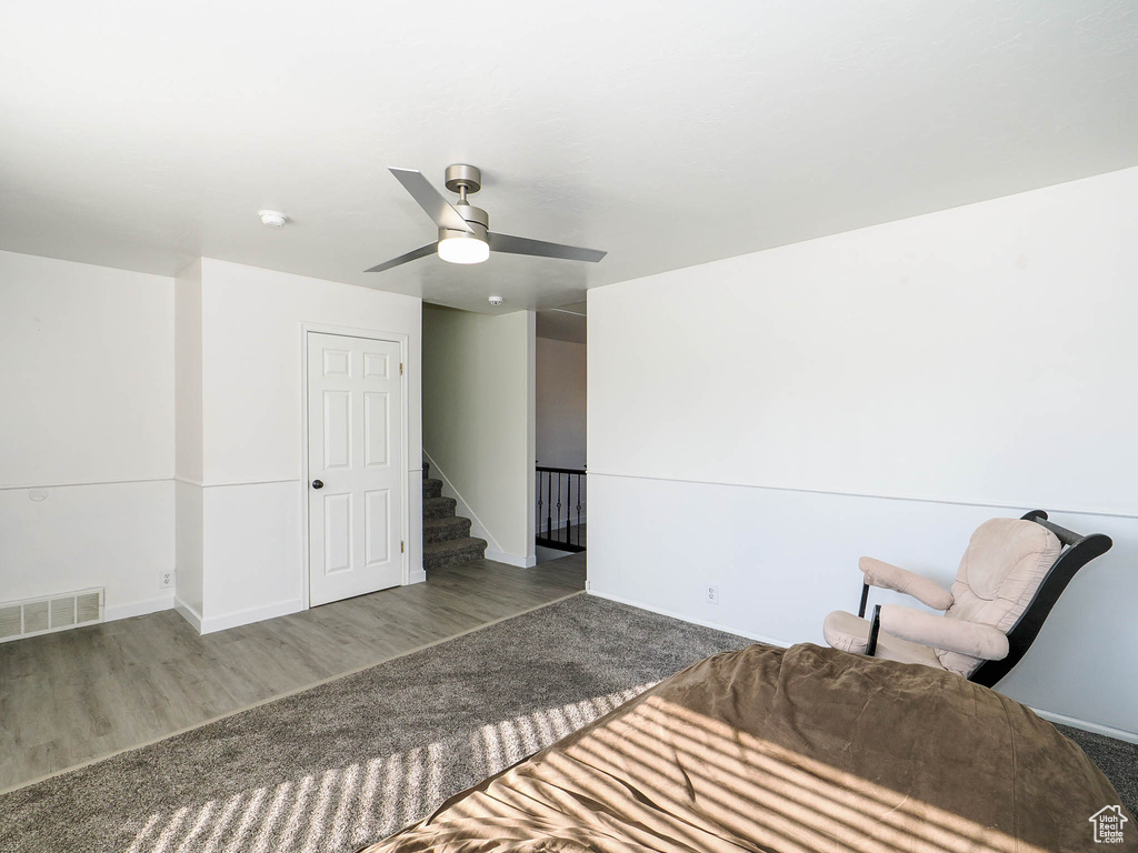 Unfurnished bedroom with ceiling fan and wood-type flooring