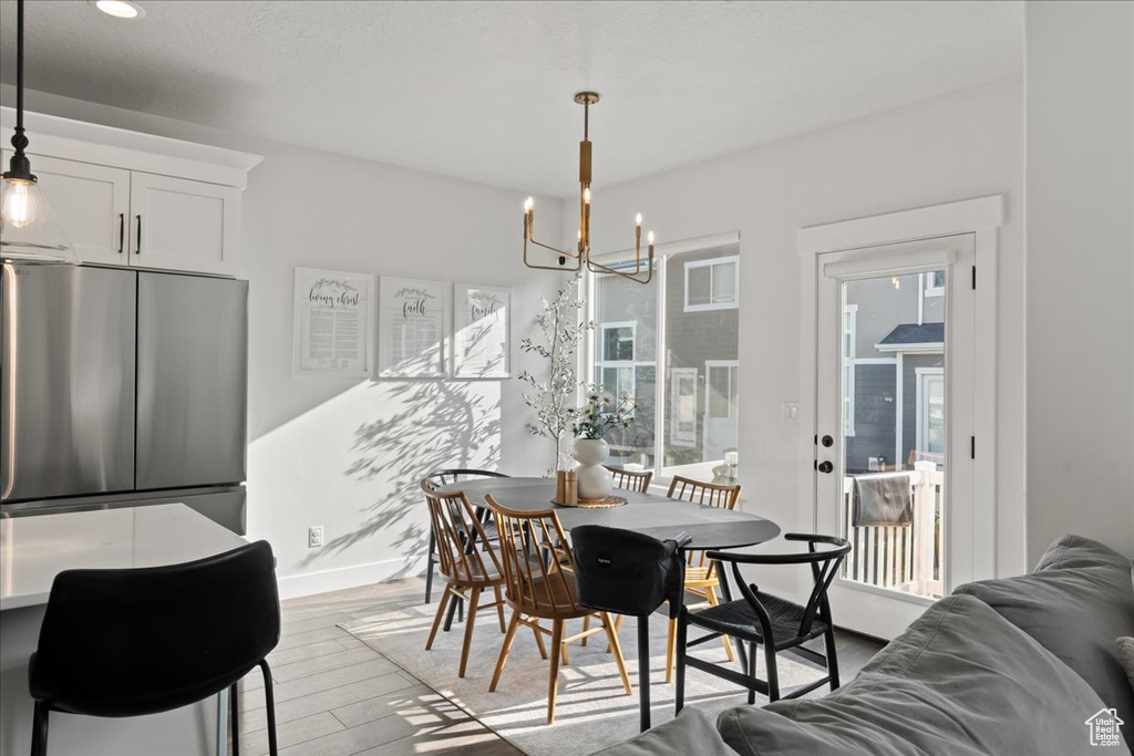 Dining room featuring light hardwood / wood-style flooring and a chandelier