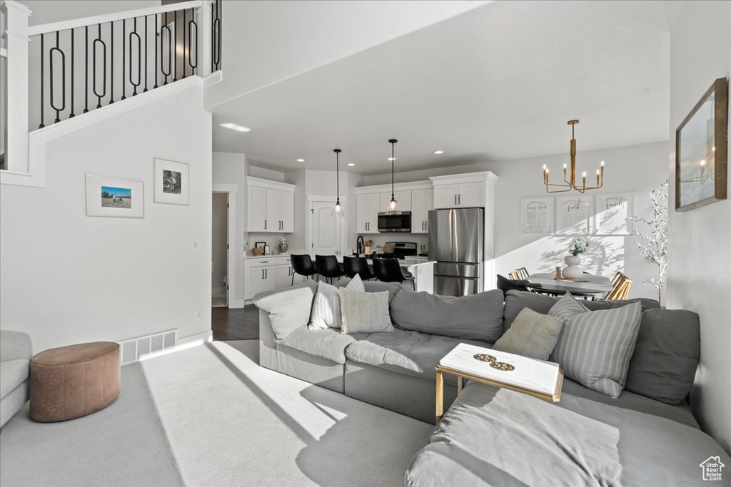 Living room with hardwood / wood-style flooring and a notable chandelier