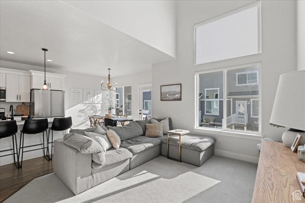 Living room with a chandelier and light hardwood / wood-style flooring