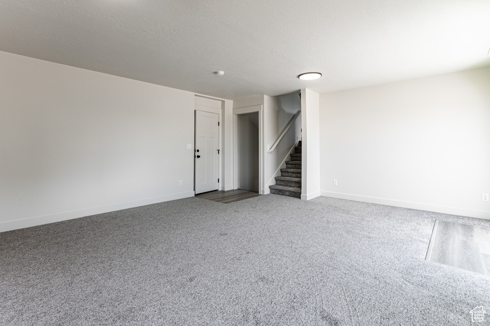 Interior space with carpet and a textured ceiling