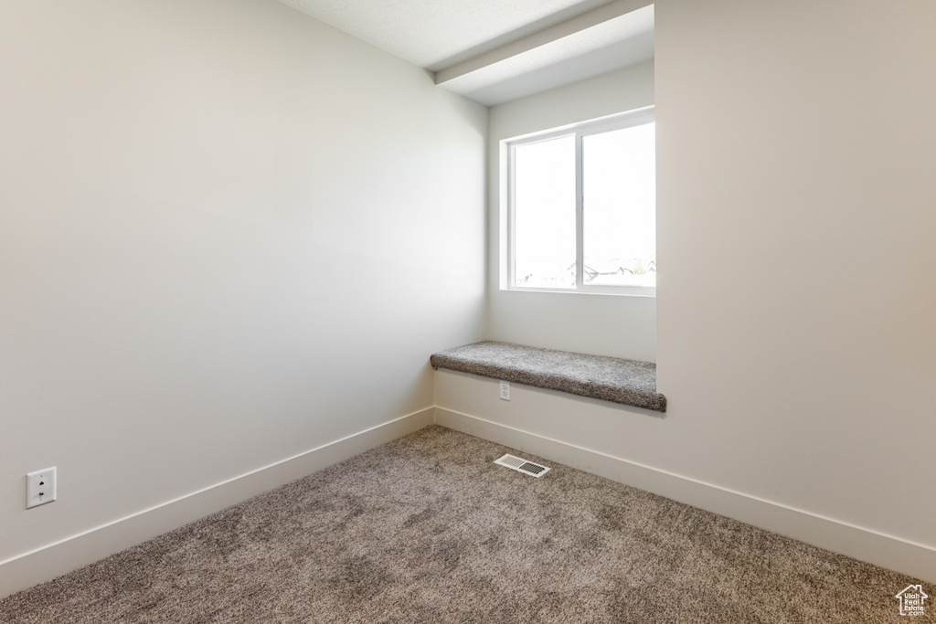 Unfurnished room featuring carpet flooring