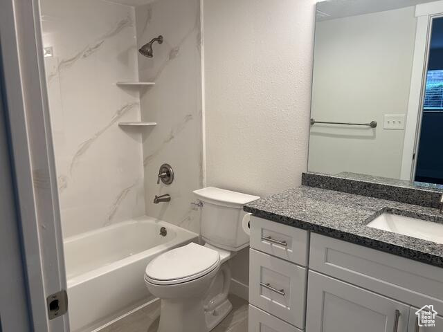 Full bathroom featuring vanity, toilet, and shower / bath combination