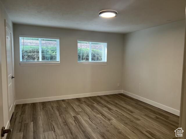 Unfurnished room with dark hardwood / wood-style floors