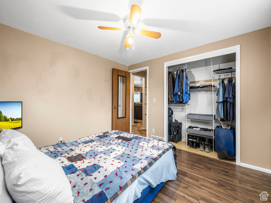 Bedroom featuring dark hardwood / wood-style flooring and ceiling fan