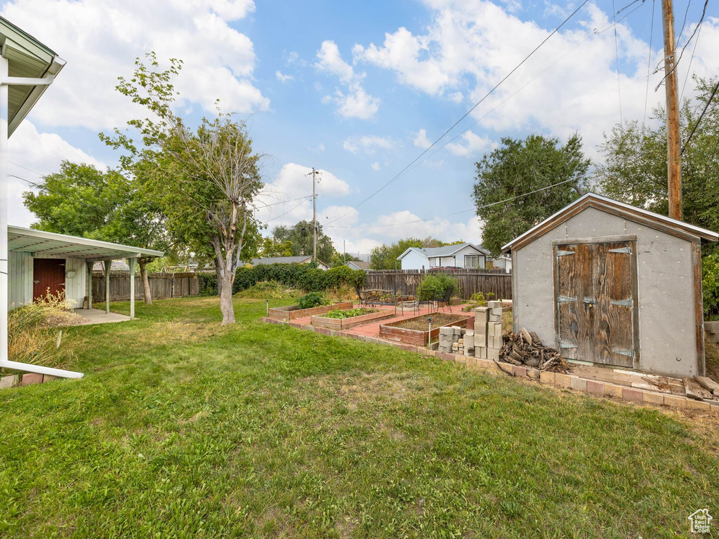 View of yard with a storage unit