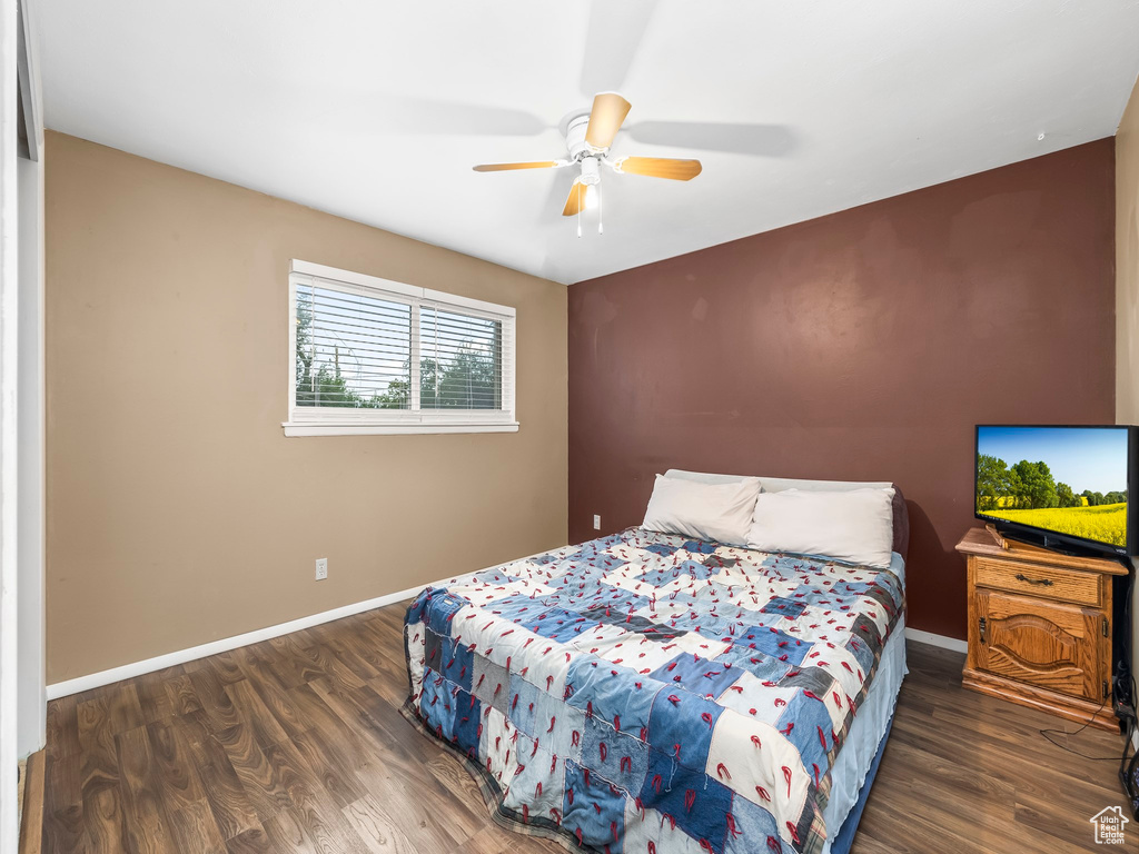 Bedroom featuring dark wood-type flooring and ceiling fan