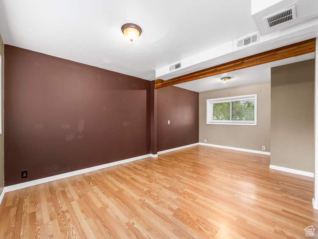 Empty room featuring light wood-type flooring