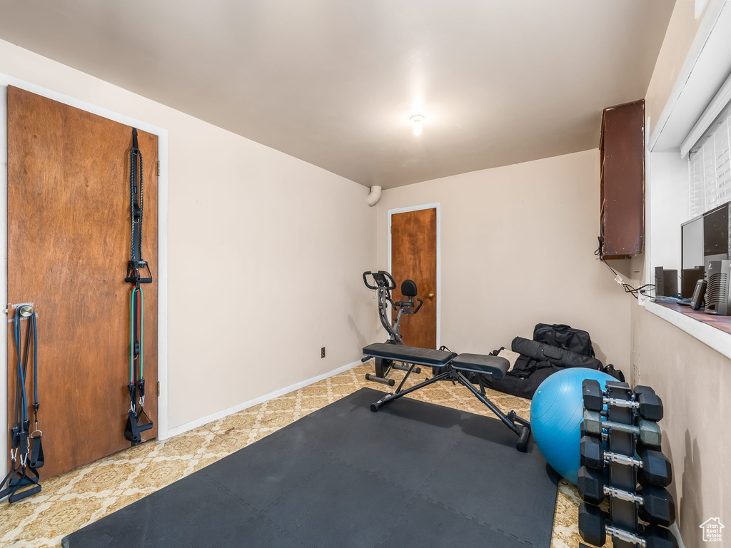 Exercise room featuring light tile patterned floors