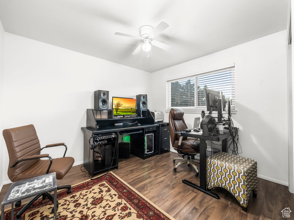 Office featuring dark wood-type flooring and ceiling fan