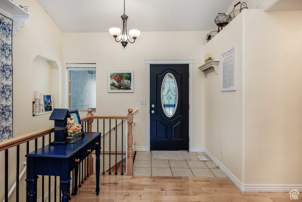 Entryway featuring a notable chandelier and light hardwood / wood-style flooring