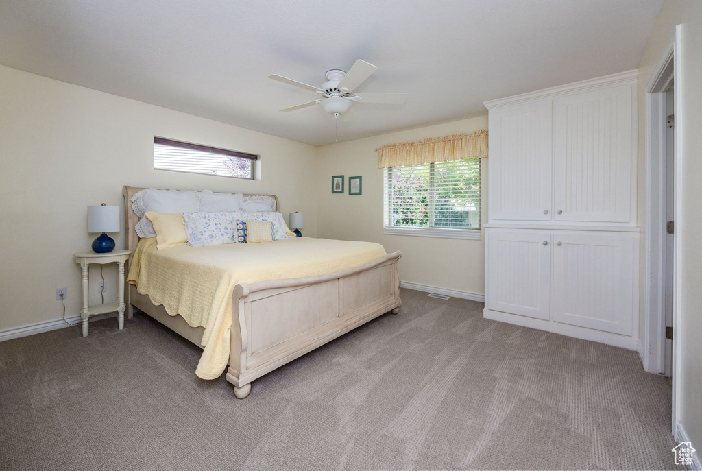 Unfurnished bedroom with a closet, ceiling fan, and light carpet