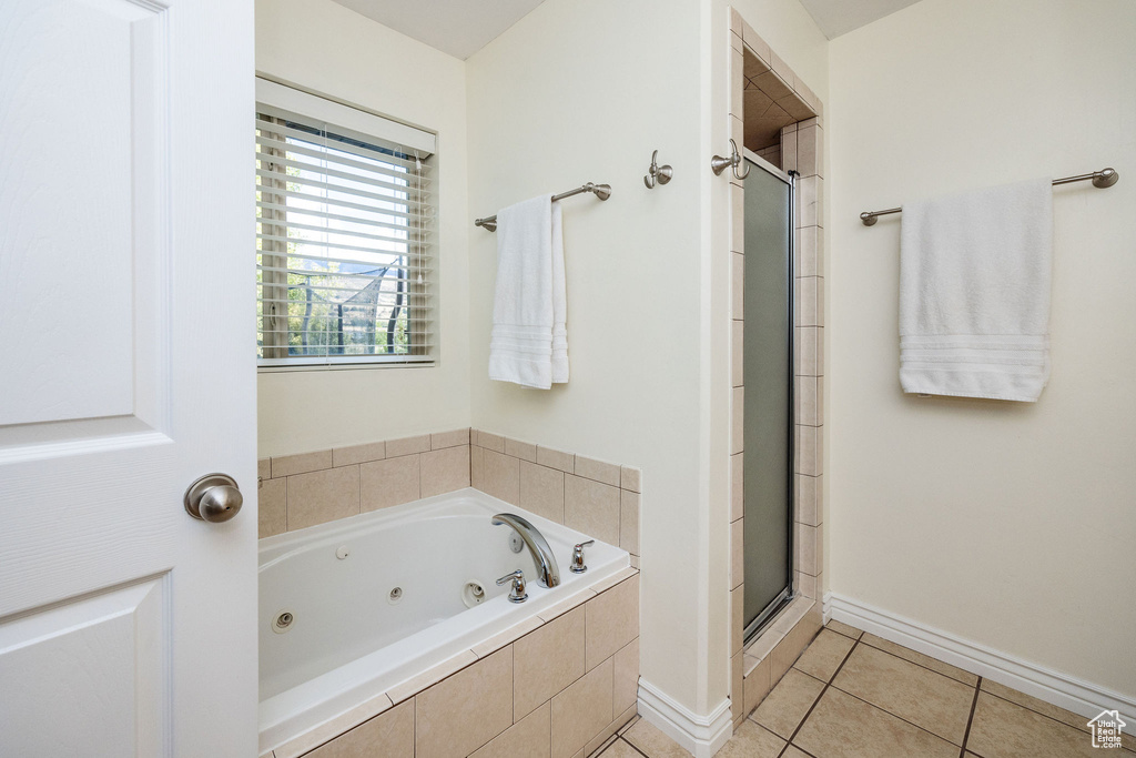 Bathroom featuring separate shower and tub and tile patterned floors