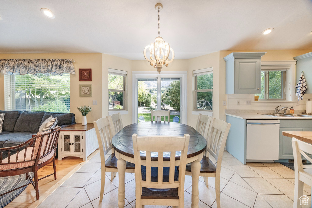 Dining room featuring a notable chandelier, sink, and light tile patterned floors