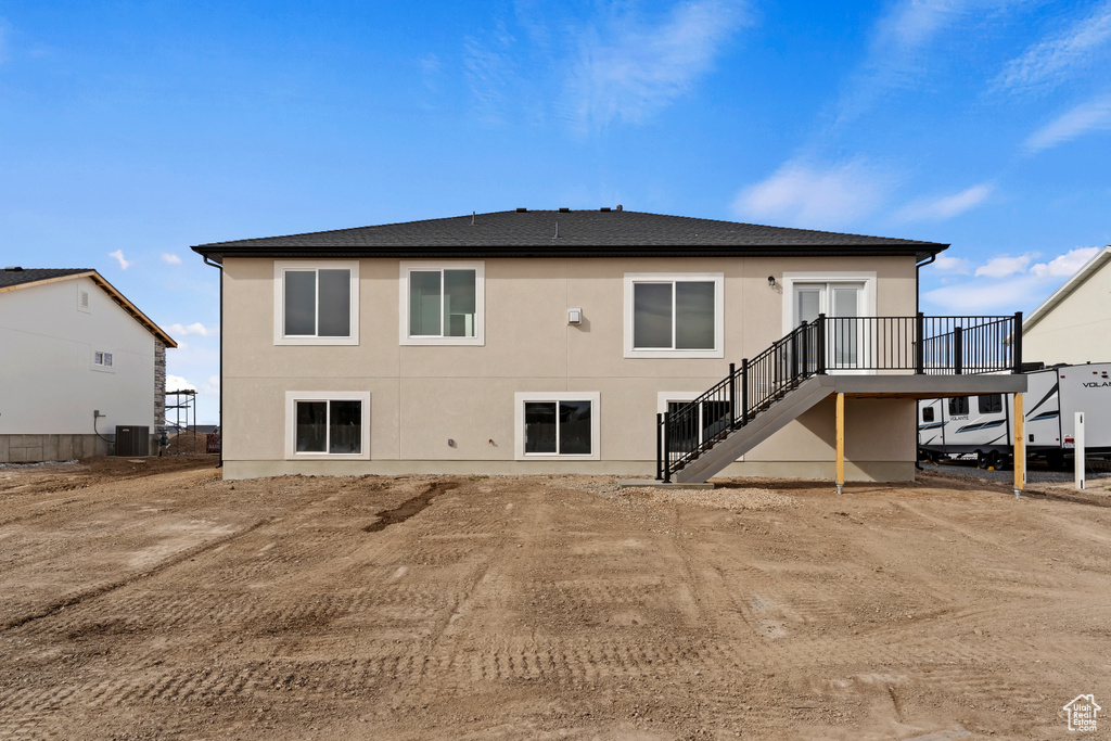 Back of house featuring central AC